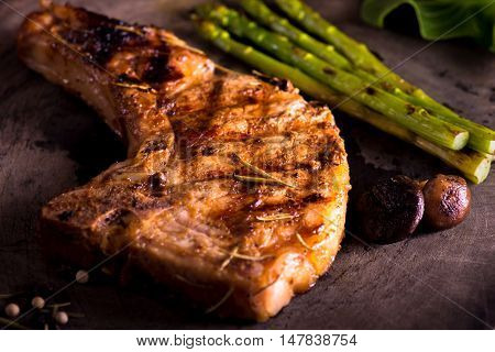 grilled pork chop with vegetable on wooden board