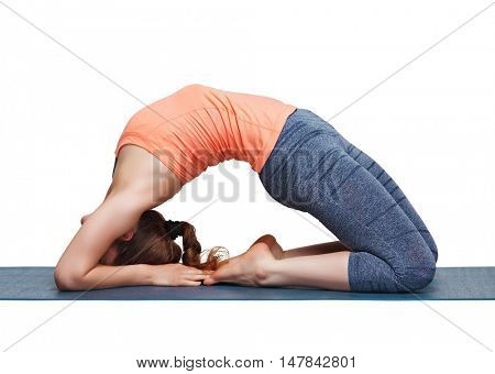 Beautiful sporty fit yogini woman practices yoga asana Kapotasana - pigeon pose intense backbend in studio isolated on white
