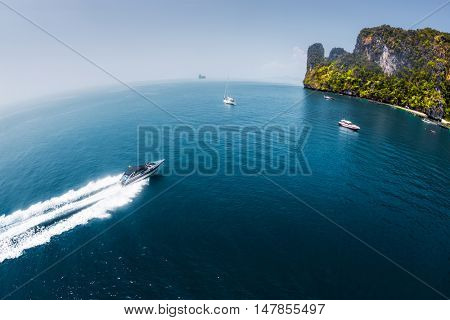 View of the island in Andaman sea with speedboat in a clear water, Thailand