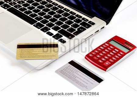 Online shopping concept with creadit cards, laptop and coffee