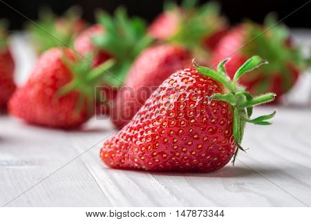 Red Strawberry, red close up strawberries with selective focus on a strawberry with many strawberries in the background for food or fruit close up background or strawberry texture.