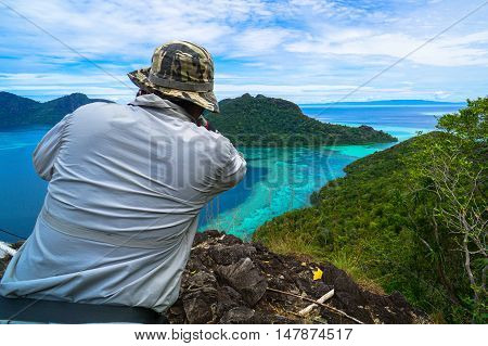 Tourists enjoying amazing view from top of Bohey Dulang island Semporna,Sabah.The greatest tourist attraction of Semporna with bright blue water & rocky shore in the islands