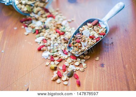 Healthy Vegan Coconut Granola in a Scoop with Nuts, Gogi Berry. Healthy breakfast. Selective focus. Close-up.