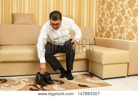 DUNNO UKRAINE - 02 September 2016: Groom wearing classic shoes on wedding day