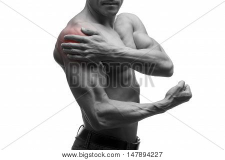 Man with pain in shoulder ache in muscular male body isolated on white background with red dot black and white photo