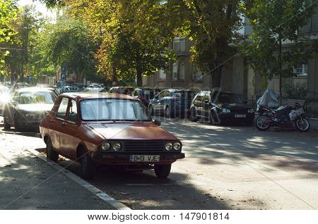 Bucharest, ROMANIA - August 21 2016: An old red Dacia car on the streets in Bucharest. Dacia is one of Romania's top companies. BUCHAREST -August 21 2016