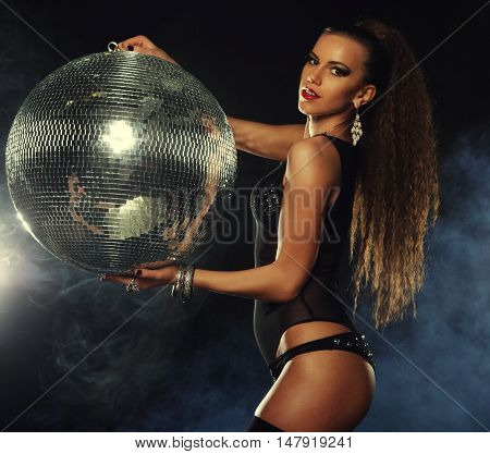 young dancer girl in smoke with disco ball