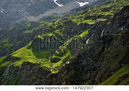 little alpien waterfalls and steams on summer green hills