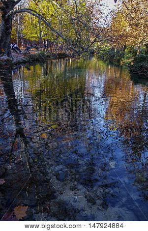 Autumn Landscape With Colorful Leaves, River And Reflections In Water