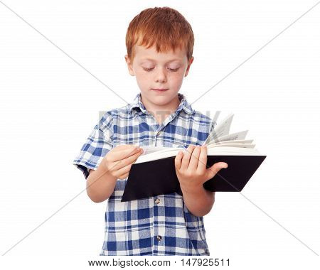 Little studious boy reading a book isolated on white background