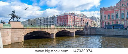 SAINT PETERSBURG RUSSIA - APRIL 25 2015: The statues of the Horse Tamers at four corners of Anichkov Bridge across Fontanka River on April 25 in Saint Petersburg.