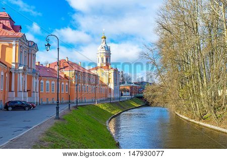 The colorful Northen (Prosfornyi) Building and the Riznica tower of Alexander Nevsky Lavra (Monastery) located at the embankment of Monastyrka river Saint Petersburg Russia.