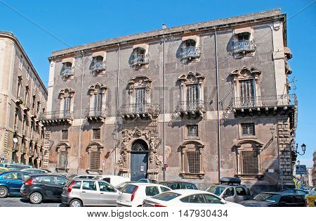 CATANIA ITALY - OCTOBER 10 2012: The old Palace-hotel in Manganelli Square surrounded by car parking on October 10 in Catania.