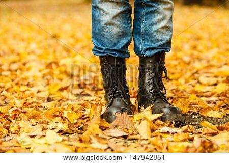 Nature outdoor foliage relax concept. Man in black boots. Male in leather footwear jeans trousers standing outside.