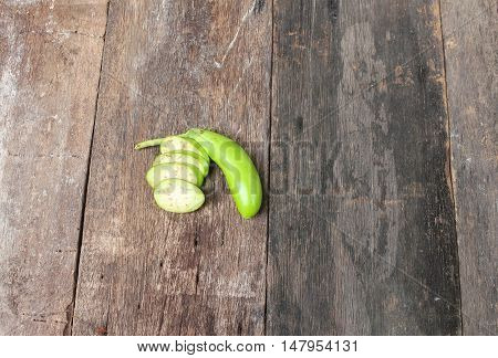 Fresh Eggplants one cut in slices on a wooden. Summer fresh vegetables. (Solanum melongena) and copy space.