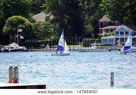HARBOR POINT, MICHIGAN / UNITED STATES - AUGUST 1, 2016: People enjoy a sailing lesson, provided by Little Traverse Sailors, off the shore of Harbor Point.