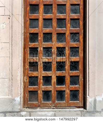 Old wooden door with glass windows many layers of brown varnish