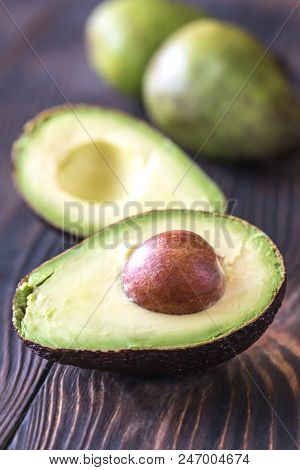 Halved Avocado On The Wooden Background