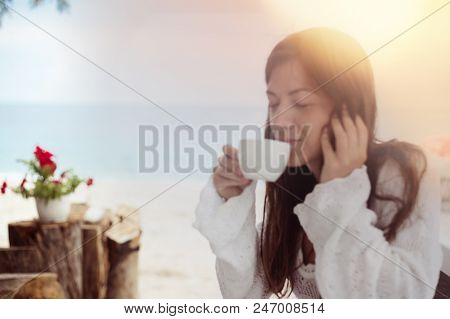 Blurred Background With Girl Enjoy Her Aromatic Coffee Drink On A Beach. White Clear Cup From A Cafe