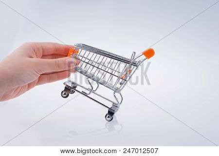 Hand Holding A Cart On A White Background