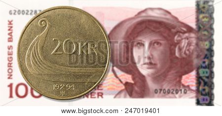 20 Norwegian Krone Coin Against 100 Norwegian Krone Bank Note Obverse