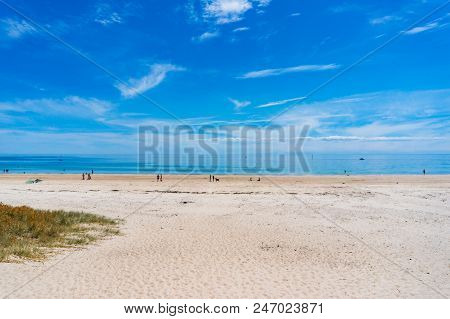 South Australia, Australia - November 13, 2017: People With Pets Relaxing On Seacliff Beach In Holdf