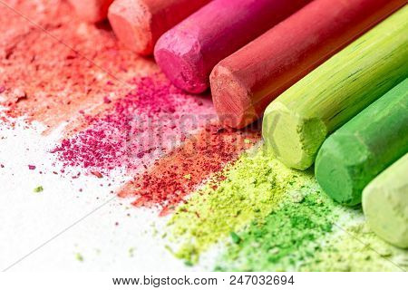 Crumb And Chunks Of Multi-colored Chalk, Pastels On White Paper For Watercolor. Yellow, Pink, Red, C