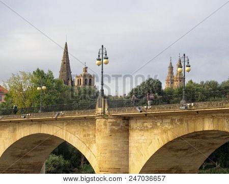 Pilgrims Cross The Stone Bridge (puente De Piedra) Over The Ebro River - Logrono, La Rioja, Spain