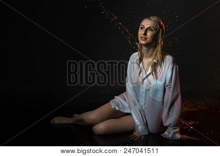 Nice Girl In The White Shirt And Water Drops Behind And Arround Her Illuminated By Light During A Ph