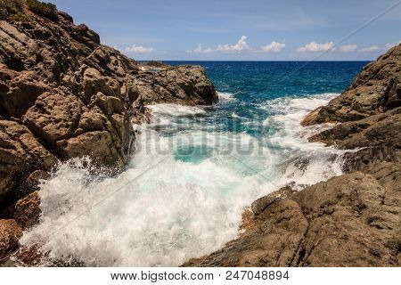 Tide in a small rocky cove on an island in BVI