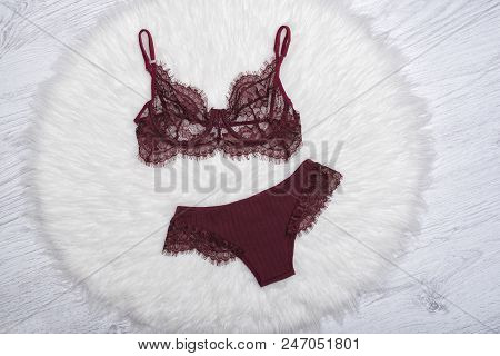 Burgundy Lace Lingerie On The White Fur. Fashion Concept