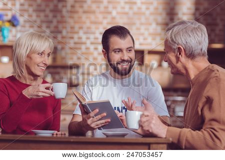Keep Smiling. Handsome Bearded Man Expressing Positivity While Looking At His Interlocutor