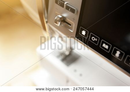 Close Up Of Modern Computerised Sewing Machine  In Bright Sunny Light - Control Buttons And Touchscr