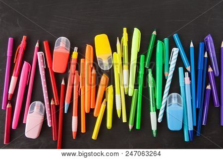 Variety Of Colorful Pens In A Rainbow On Black Background