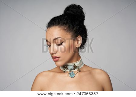 Beauty Closeup Portrait Of Beautiful Mixed Race Woman Wearing Chocker Posing, Isolated On Gray Backg