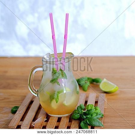Cold Summer Drink, Lemonade With Lime And Basil On The Basis Of Sparkling Water And Sugar Syrup In A