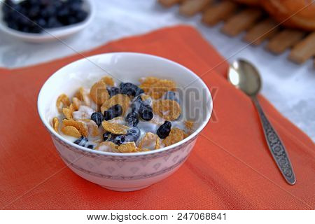 Summer Breakfast, Natural Yoghurt With Cornflakes And Berries Of Edible Honeysuckle