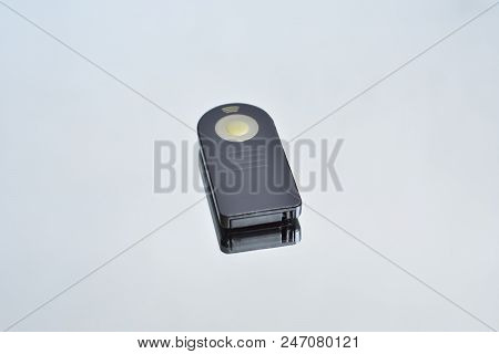Remote Shutter Release Control For The Camera, And Its Reflection On The Mirror Surface, On An Isola
