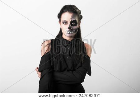 Studio Portrait Of Beauty Brunette Woman Wearing Black Clothes With Scary Greasepaint On Face Standi