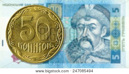 50 Kopiyka Coin Against 5 Ukrainian Hryvnia Bank Note Obverse