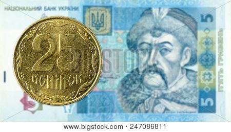 25 Ukrainian Kopiyka Coin Against 5 Ukrainian Hryvnia Banknote