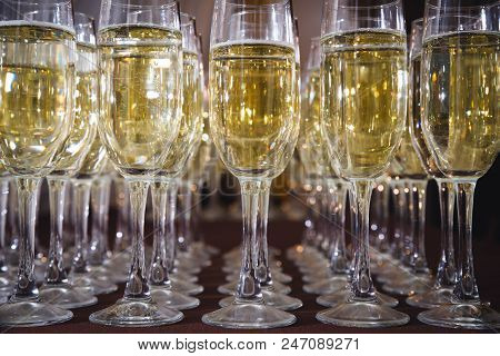 Champagne Flutes In Holiday. A Number Of Glasses
