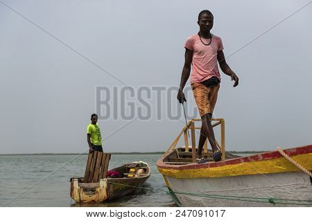 Cacheu, Republic Of Guinea-bissau - February 1, 2018: Fishermen Preparing Their Canoes In The Port O