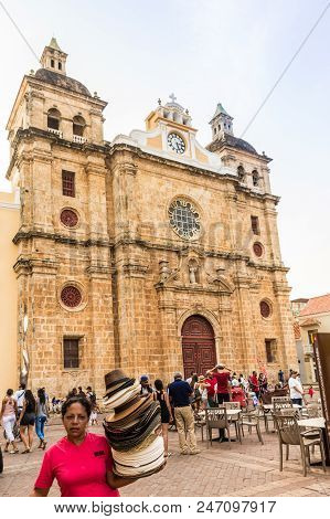 Cartagena, Colombia. March 2018. A View Of A Street Seller Selling Hats In Front Of San Pedro Claver