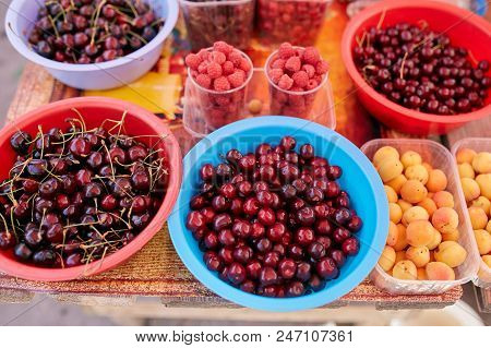 Sweet Cherry, Raspbeery And Apricot On A Farm Market In The City. Fruits And Vegetables At A Farmers