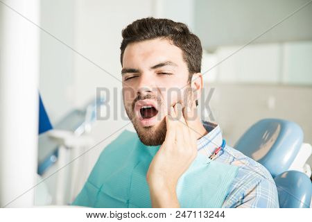 Mid Adult Male Patient Suffering From Toothache In Dental Clinic