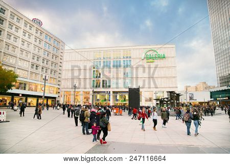 BERLIN GERMANY - OCT 29, 2016: People near fountain on Alexanderplatz square in Berlin city on Oct 29, 2016. Germany. Alexanderplatz is large public square and transport hub in central Mitte district