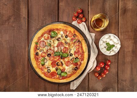 Overhead Photo Of Pepperoni Pizza With Glass Of White Wine, Cherry Tomatoes And Mozzarellini Cheese,