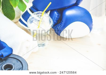 Set For Sports, Towel, Boxing Gloves, Dumbbell And A Bottle Of Water On A Light Background. The Conc