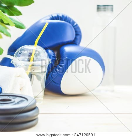 Set For Sports, Towel, Boxing Gloves, Dumbbell And A Bottle Of Water On A Light Background. The Conc